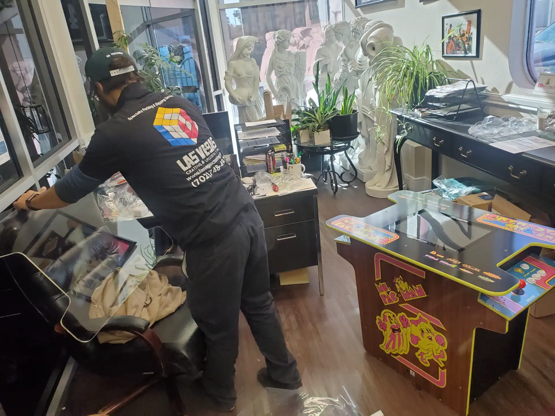 Craftsman crating a painting in the warehouse